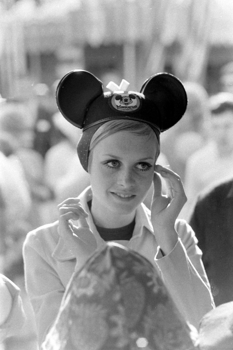 British model Twiggy (born Lesley Hornby, later Lawson) adjusts a pair of Mickey Mouse 'ears' at Disneyland, Anaheim, California, 1967. (Photo by Ralph Crane/The LIFE Picture Collection/Getty Images)